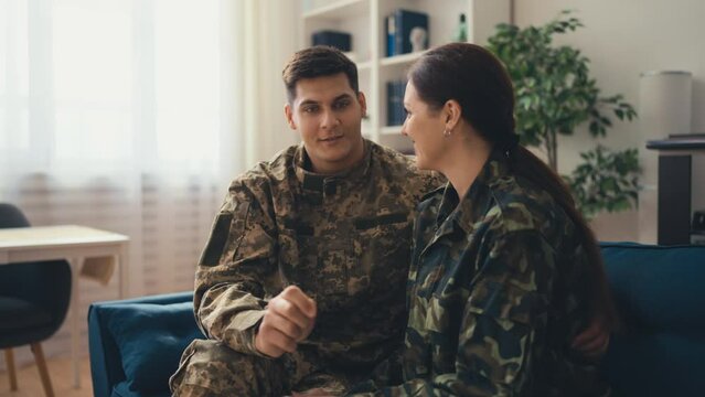 Smiling Military Couple Having Conversation At Home, Close Relationship, Reunion