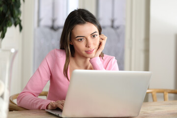 Fototapeta premium Woman at home using laptop