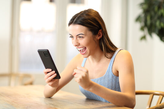Excited woman checking phone content