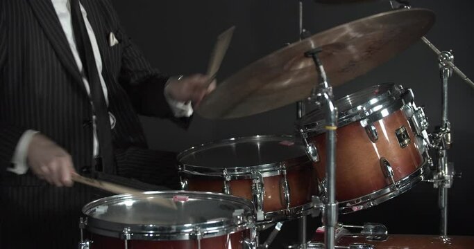 Fast paced beat is being played with a drum set by a professional musician, 4k