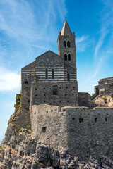 Headland in Portovenere or Porto Venere with the medieval church of San Pietro (St. Peter, 1198), UNESCO world heritage site. La Spezia, Liguria, Italy, Europe.