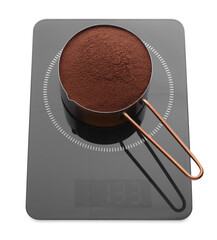 Modern kitchen scale with saucepan of cocoa powder isolated on white