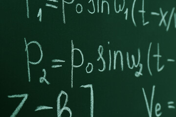 Fototapeta na wymiar Many different math formulas written on chalkboard, closeup