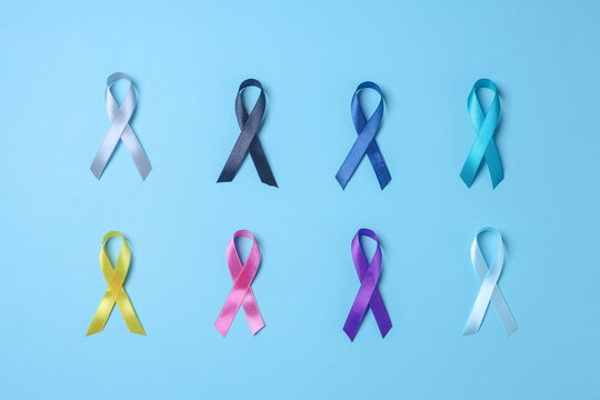 World cancer day. Colorful awareness ribbons on blue background for supporting people living and illness. 