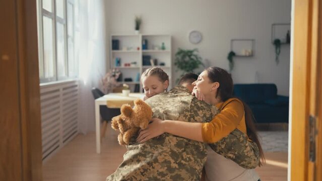 Young woman and little daughter meeting father from war, happy family reunion
