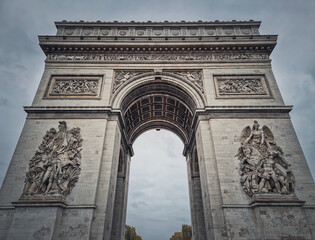 Obraz premium Triumphal Arch (Arc de triomphe) in Paris, France. Closeup architectural details of the famous historic landmark.