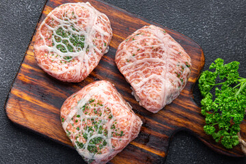 cutlet ground meat in fat grid fatty mesh pork, beef raw minced meat fresh meal snack on the table copy space food background rustic top view