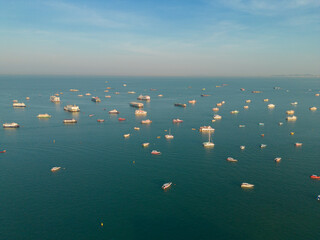 Aerial view of boats in Pattaya sea, beach with sunset sky for travel background. Chonburi, Thailand.