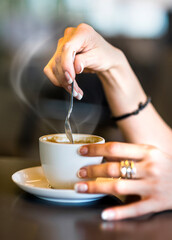 Female hands with a coffe cup at a cafe. Take a break and escape from the hustle and bustle of the city and offices.