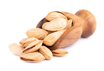 Mountain almonds in wooden scoop, isolated on white background. Uzbek wild almonds.