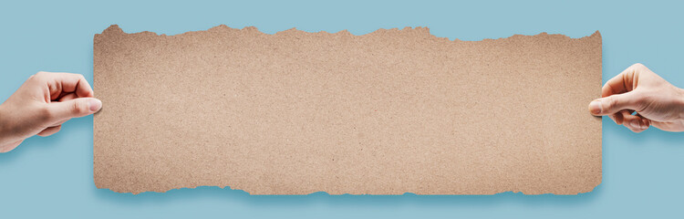 Man and woman holding a blank sign with torn edges