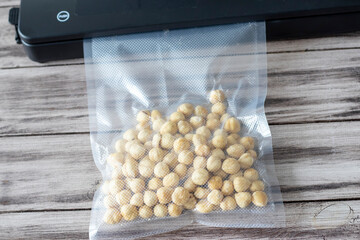 The vacuum draws air from the vacuum bag with the pound cake and seals it. The vacuuming process.