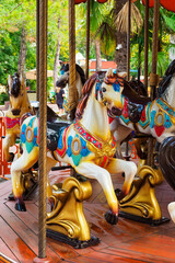 Fototapeta na wymiar carousel with horses in the amusement park