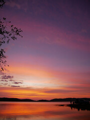 Fototapeta na wymiar Sunset in the evening at a reservoir behind a dam.