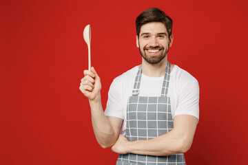 Young smiling cheerful happy fun male housewife housekeeper chef cook baker man wearing grey apron...