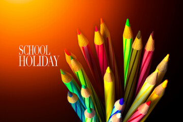 Concept of School holiday  with inscription, color pencils on black background with flare. .