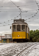 Fototapeta na wymiar The famous, old, yellow trams travelling around the streets of Lisbon, Portugal