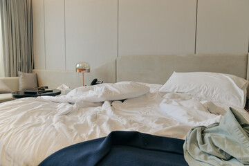 Unmade bedding sheets and pillow. Unmade messy bed after comfortable sleep concept