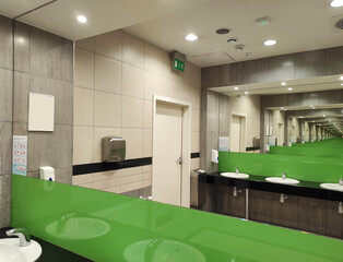 modern public toilet interior. commercial bathroom. reflection in the mirror