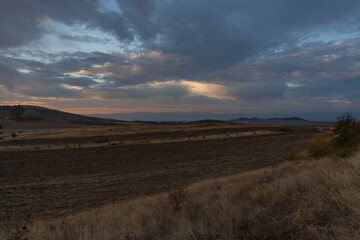 Fototapeta na wymiar Sunrise and dramatic sky over the fields in Bulgaria