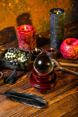 Crystal ball and magic attributes of fortune teller on wooden table
