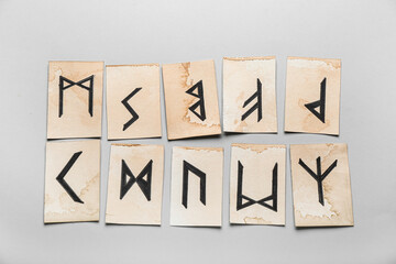 Paper cards with Elder Futhark runes on white background