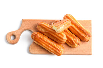 Wooden board with sweet eclairs on white background