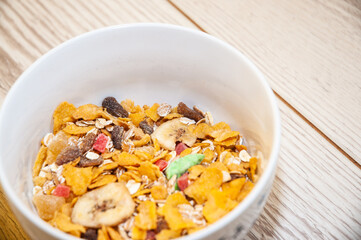 Healthy breakfast - cornflakes in a bowl on a table.