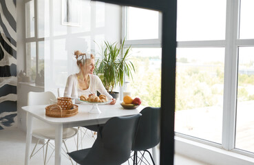 Young woman enjoying healthy breakfast on home kitchen