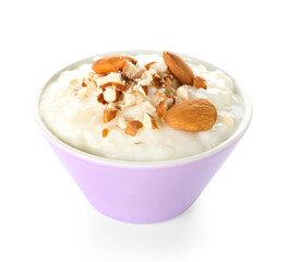 Bowl with delicious rice pudding, raisins and almond on white background