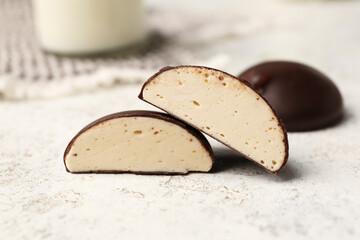 Chocolate bird's milk candies on grunge background