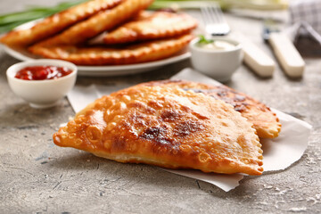 Tasty chebureks on grunge background
