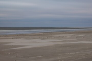 View of wide sandy beach of Vejers in Denmark in evening light