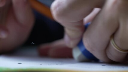 Closeup hand erasing mistake on paper. Macro extreme close up of person using eraser with pencil - Powered by Adobe
