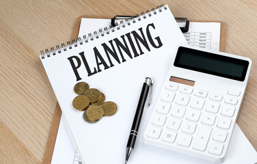 PLANNING text on a notebook with chart and calculator and coins, business concept