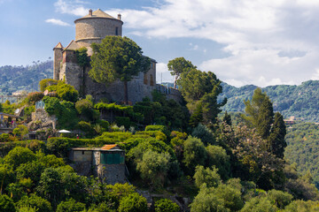 Brown Castle surrounded by green olive trees and plants in the middle of the summer. Castello Brown is a historic house museum located high above the harbour of Portofino, Italy.