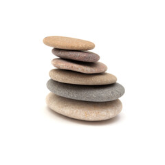 Zen pyramid made of flat pebbled of different colors isolated on white background