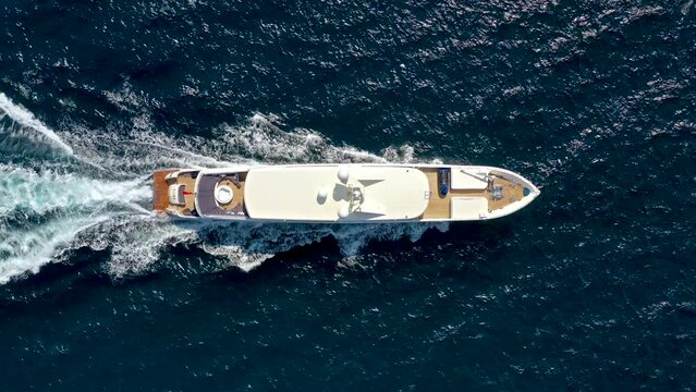 bird's eye drone view of luxury yacht cruising at sea