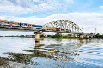 The train is going over the old bridge named Binh Loi in Hochiminh city, Vietnam. It is the first railway bridge across the Saigon River, started construction in 1898 by French engineers.