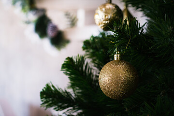 Close up of bauble balls on christmas tree. Green pie tree background. happy New Year holiday celebration concept.