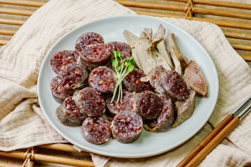 Sundae, Korean Blood Sausage : Pork intestines stuffed with glass noodles, vegetables, sweet rice, coagulated pig's blood (seonji) and steamed. Variations include Ojingeosundae (stuffed squid) and cha