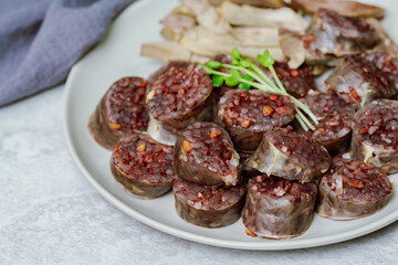 Sundae, Korean Blood Sausage : Pork intestines stuffed with glass noodles, vegetables, sweet rice, coagulated pig's blood (seonji) and steamed. Variations include Ojingeosundae (stuffed squid) and cha