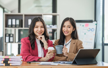 Asian company employees and colleagues work together in the office. by talking and giving advice to each other
