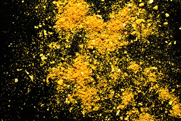 Texture pattern of yellow powder on a black background.