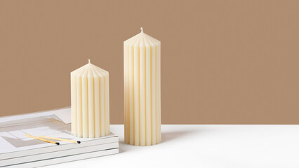 Handmade olive wax pillar candle on a neutral beige and white background. Sustainability vegan...