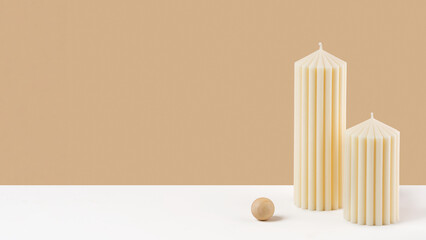 Handmade olive wax pillar candle on a neutral pastel and white background. Sustainability vegan candle, natural materials. Minimalistic, cozy atmosphere modern photo. Copy space. Banner