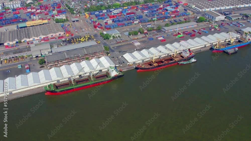 Poster Cargo containers in busy port, Shipping harbor, logistics, Shipyard Aerial, container terminal shanghai at dusk, cargo ship in the export and import business and logistics international in urban city.