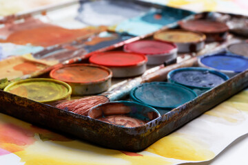 vintage paintbox with old colors inside rusty metal box and paint brush