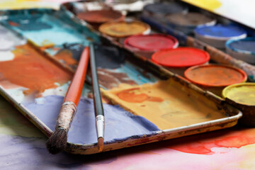 Obraz premium vintage paintbox with old colors inside rusty metal box and paint brush