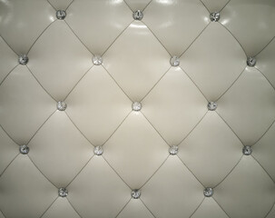 Wall or furniture surface background, cream colored leather with rhombus and diamonds shiny.
